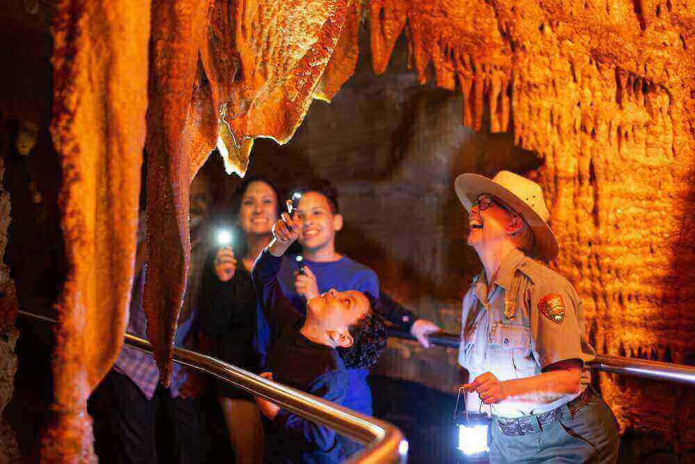 Family on a cave tour with a park ranger